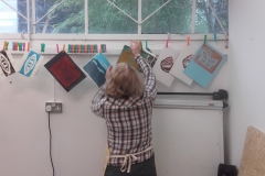 Maggie hanging proof prints to dry